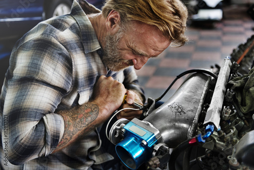 A mechanic fixing an engine