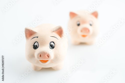 Two lucky pigs on a white background, selected focus and copy space