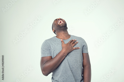 Smiling face, successful young man while standing against white background. Confident african man. Handsome afro american male.