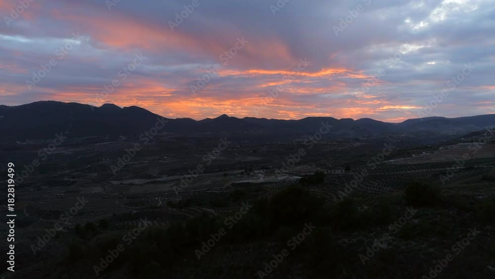 Sunset Over Arable Farms and Mountainous Landscape Sunset Over Arable Farms and Mountainous Landscape