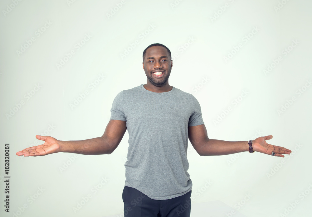 Afro american young man spread his hands in different directions. Afro american young man spread his hands in different directions.