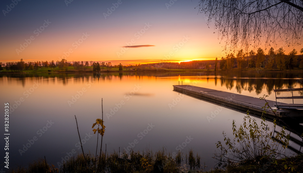 Fototapeta premium Pier in lake after sunset long exposure