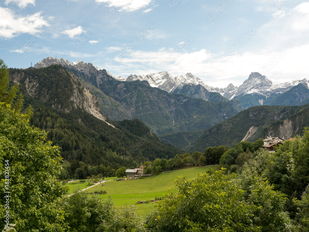 Dolomiti del brenta mountain landscape. Green grass, blue sky and clouds. Autumn, 2017