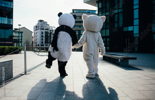 Panda and teddy bear having fun around the city