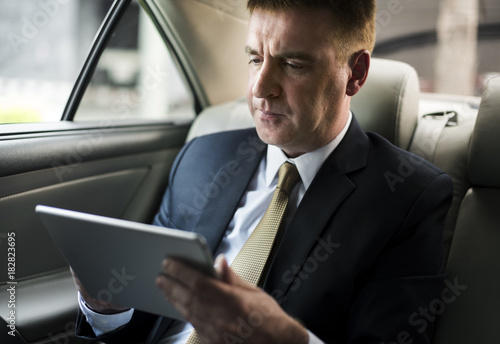Businessman Using Tablet Working Car Inside © Rawpixel.com
