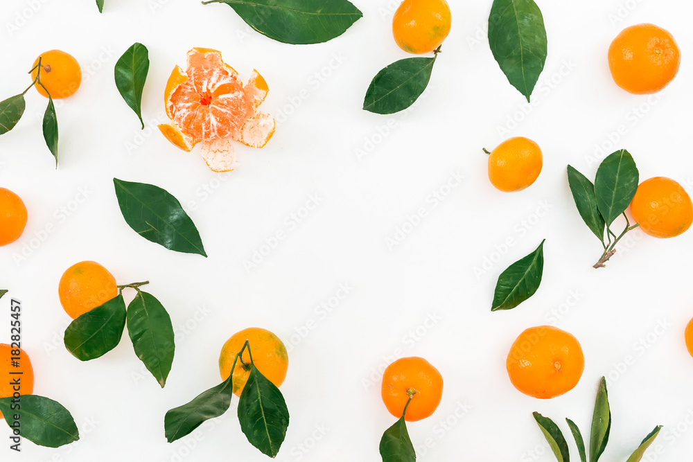Frame of citrus - mandarin and leaves on white background. Flat lay. Top view Frame of citrus - mandarin and leaves on white background. Flat lay. Top view