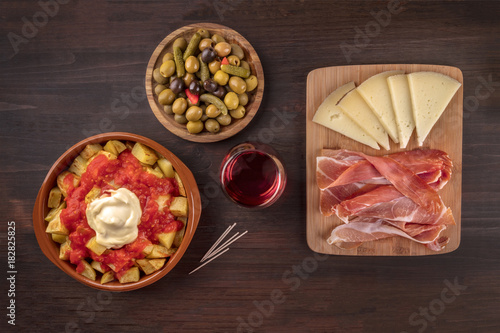 Tapas and wine. Patatas bravas, olives, jamon, cheese