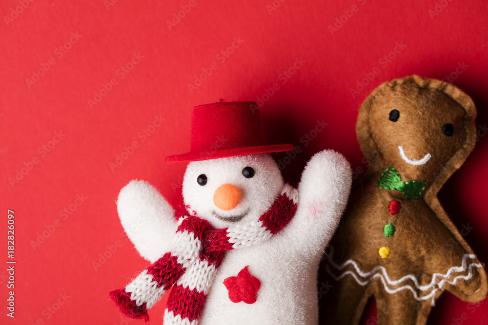 Festive snowman and gingerbread man decorations on a red background Festive snowman and gingerbread man decorations on a red background