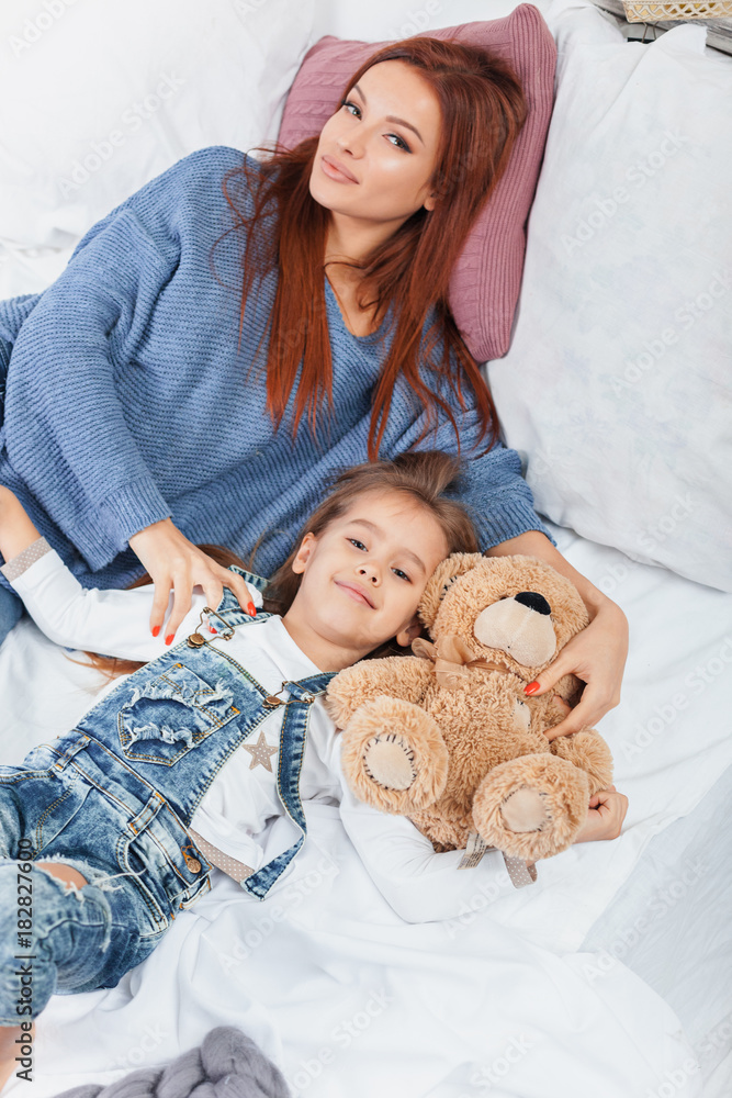 A little cute girl enjoying, playing and creating with toy with mother A little cute girl enjoying, playing and creating with toy with mother