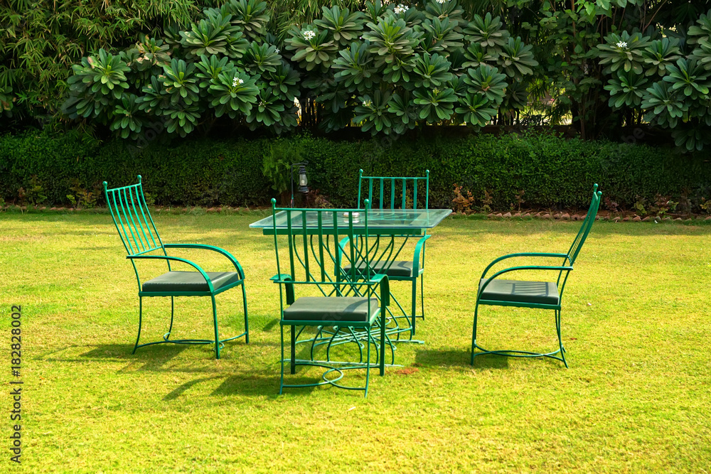Garden furniture set on lawn on sunny day Garden furniture set on lawn on sunny day