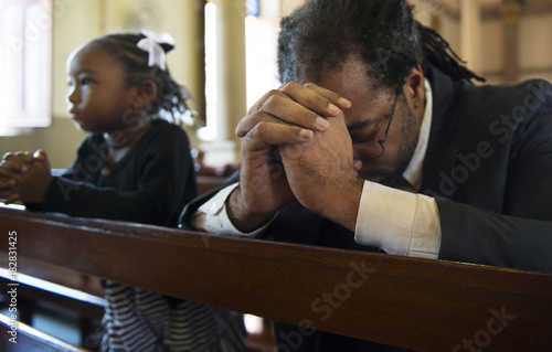 Religious man praying inside a church