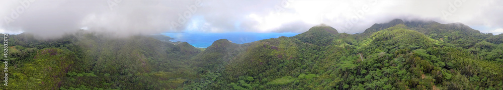 Aerial panoramic view of beautiful tropical mountains shrouded by fog
