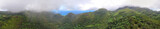 Aerial panoramic view of beautiful tropical mountains shrouded by fog