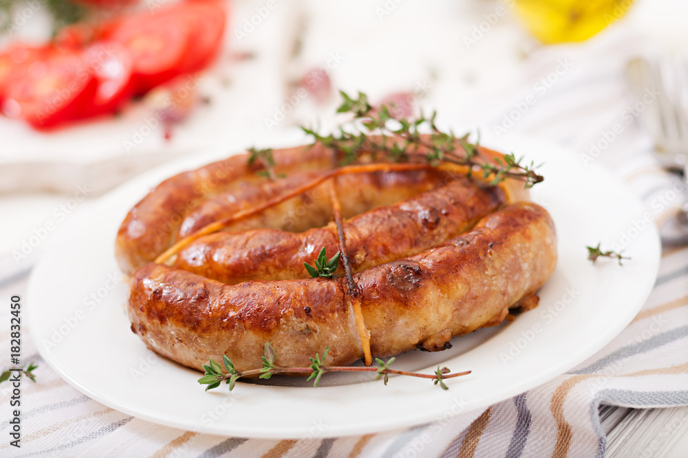 Baked homemade sausage on a white plate. Thanksgiving Day. Baked homemade sausage on a white plate. Thanksgiving Day.