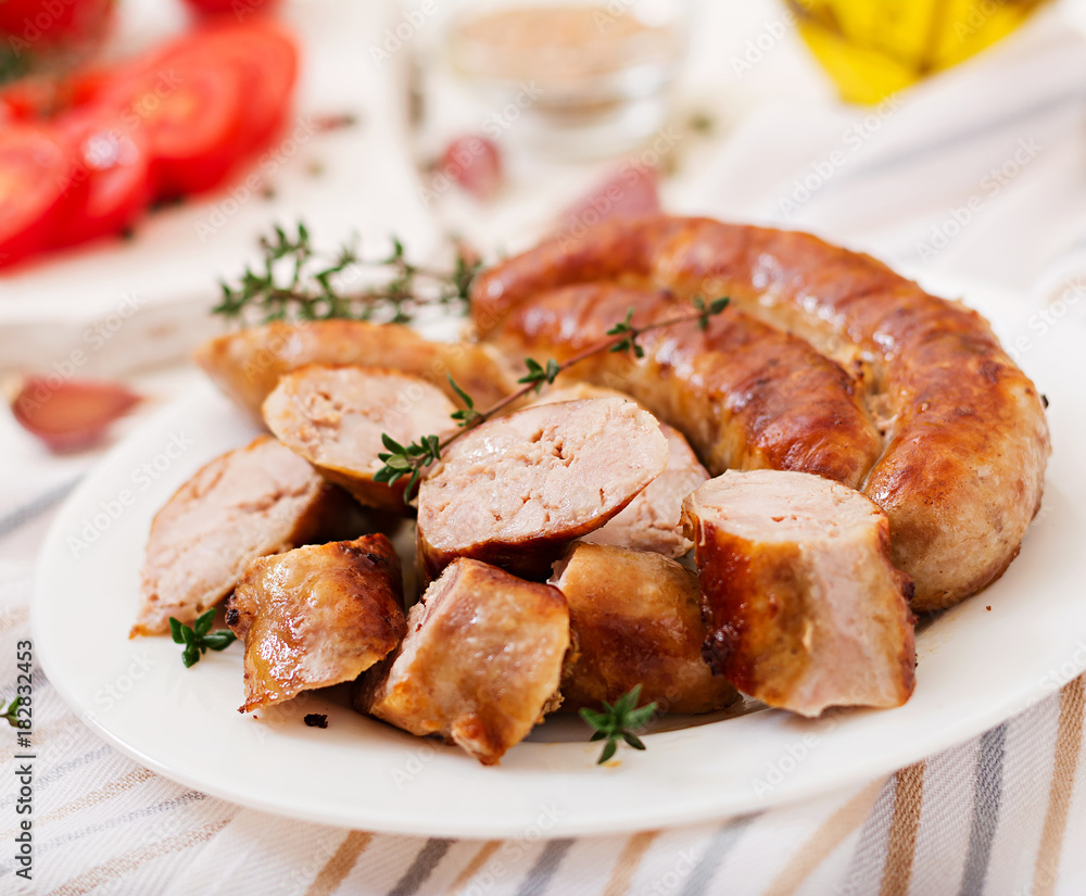 Baked homemade sausage on a white plate. Thanksgiving Day. Baked homemade sausage on a white plate. Thanksgiving Day.