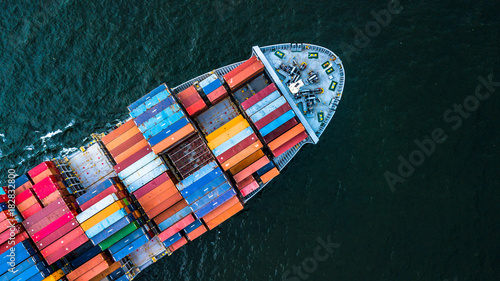 Aerial view from drone, Container cargo ship in import export business logistic and transportation of international by container cargo ship in the open sea in Asia. © Kalyakan