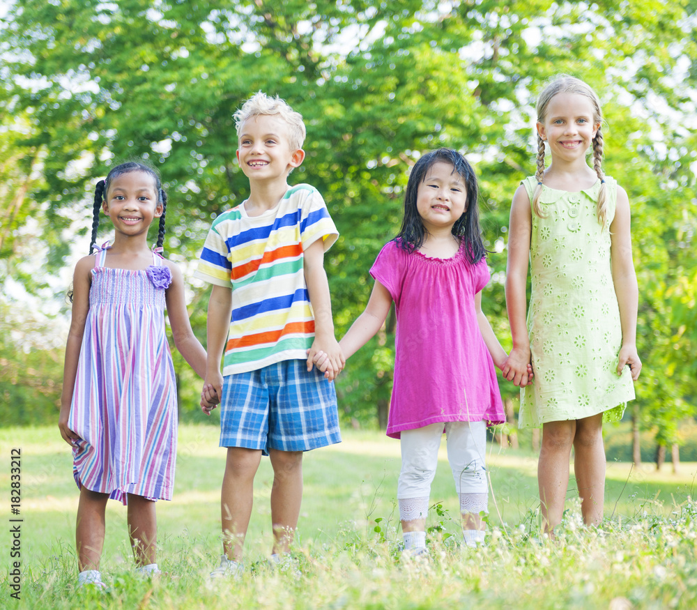 Fototapeta premium Cute diverse kids playing in the park