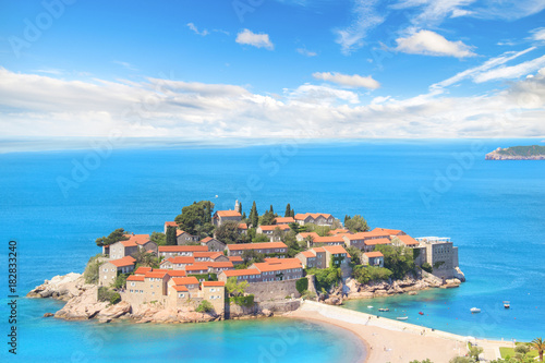 Fototapeta Naklejka Na Ścianę i Meble -  Beautiful view of the island-resort of St. Stefan (Sveti Stefan) on the Budva Riviera, Budva, Montenegro on a sunny day