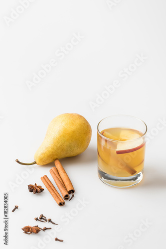 glass of delicious pear cider with spices on white © LIGHTFIELD STUDIOS