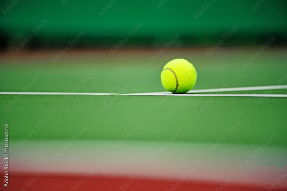 Tennis ball put on a tennis court