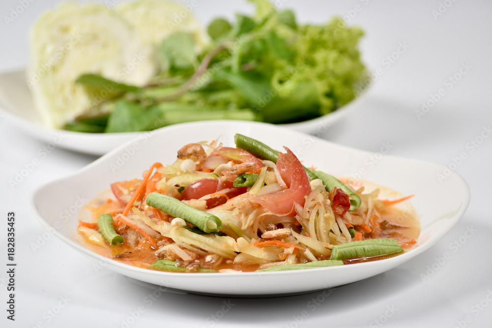 Traditional thai cuisine spicy green papaya salad on white background Traditional thai cuisine spicy green papaya salad on white background