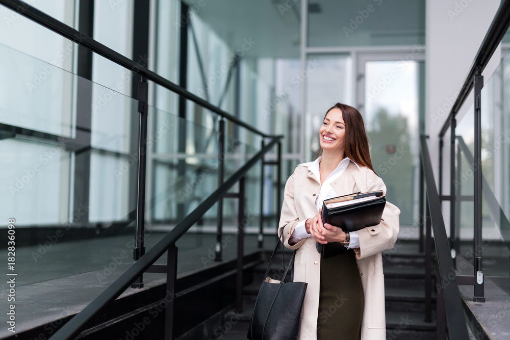 Obraz premium Portrait of young beautiful businesswoman going to office