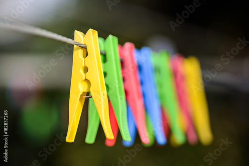 Colorful pegs on clothesline