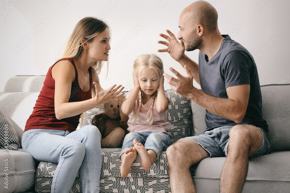 Little girl between arguing parents at home