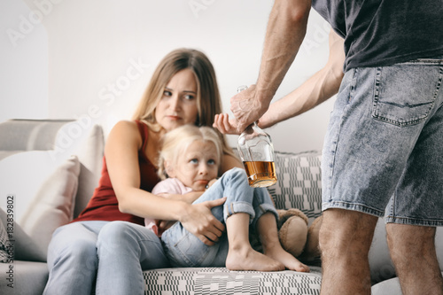 Man abusing his wife and da...