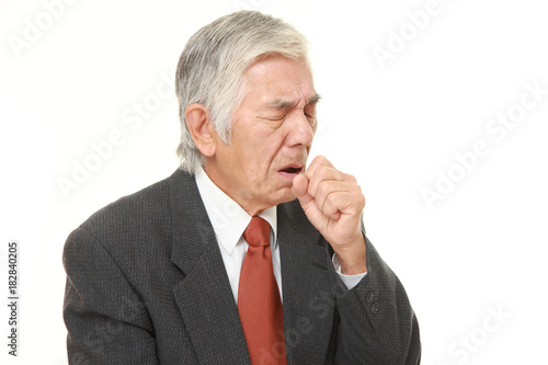 senior Japanese businessman coughing photo