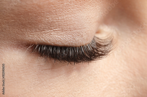 Closed female eye with long...