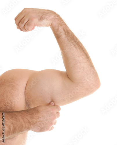 Overweight man touching fat on his arm against white background