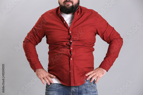 Overweight young man in tig...