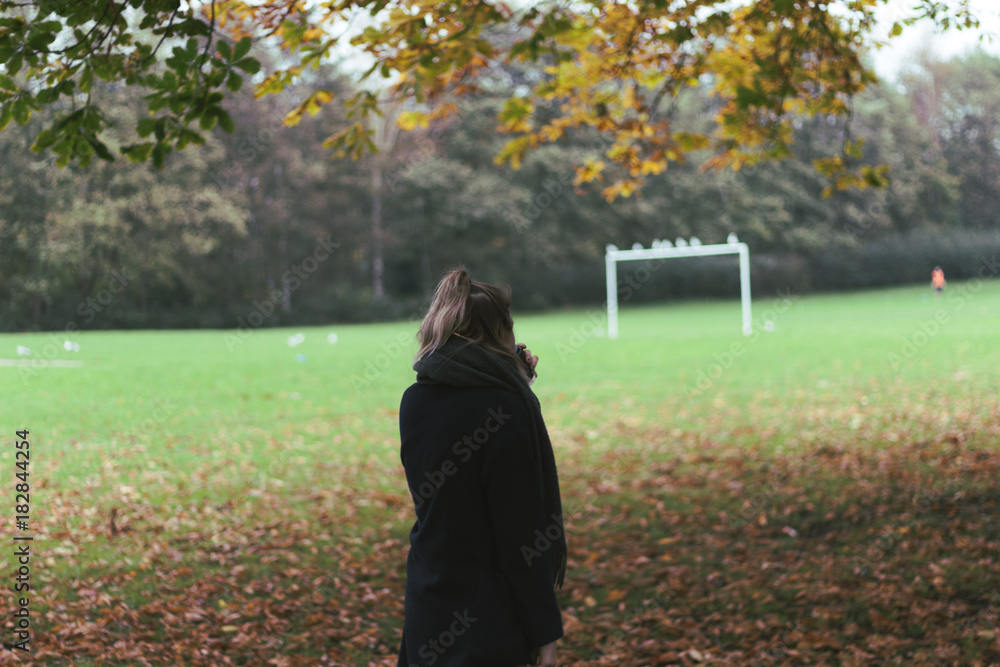 woman walking in the park in autumn