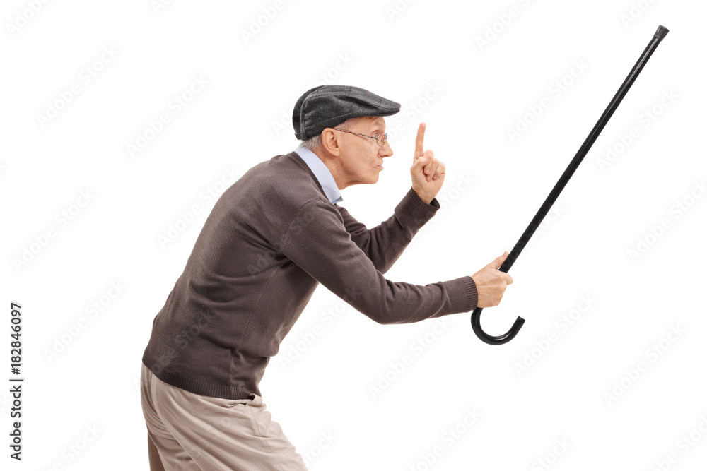Angry senior holding his cane as a sword and gesturing with his finger Angry senior holding his cane as a sword and gesturing with his finger