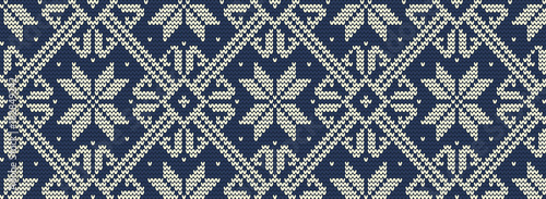 Knitted pattern on a blue background. Ornament. Seamless border. It can be used as a background. Vector illustration.
