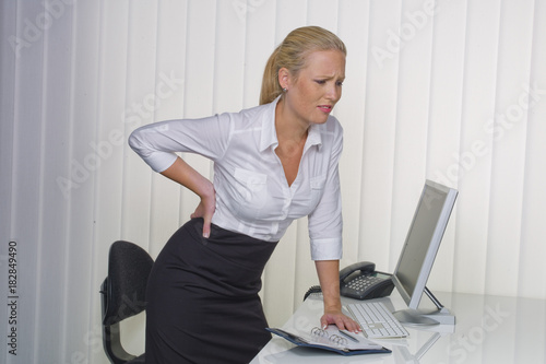 women in the office with back pain photo