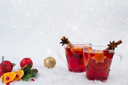 Christmas mulled wine and ingredients. On white snow background with copyspace