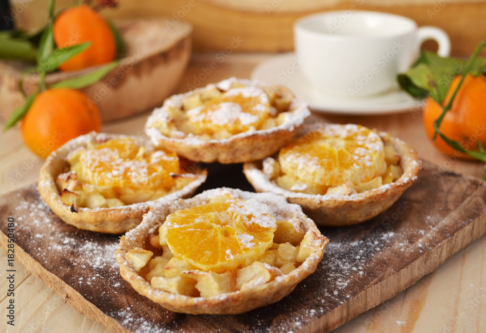 Homemade fruit tarts with caramelized apple and tangerine. Homemade fruit tarts with caramelized apple and tangerine.