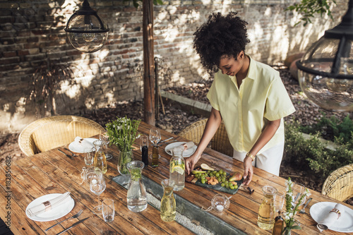 Pretty Smiling Woman Decorating Table