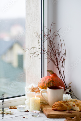 Cup of tea and bread near the window. Lifestyle of the autumn. Pumpkin