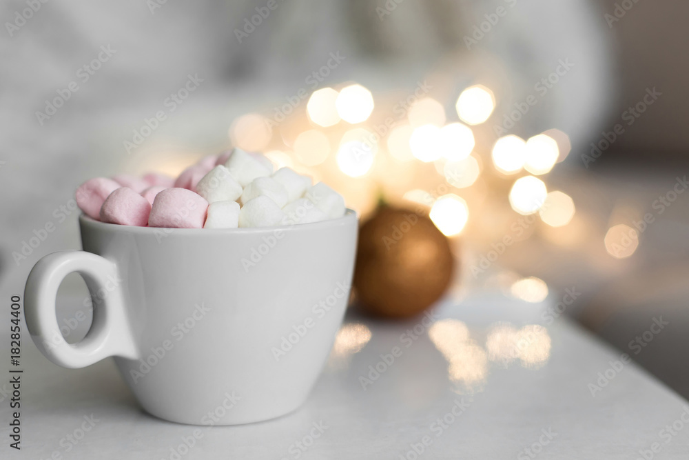 Cup of hot chocolate and marshmallow in the background of Christmas decorations. Cup of hot chocolate and marshmallow in the background of Christmas decorations.