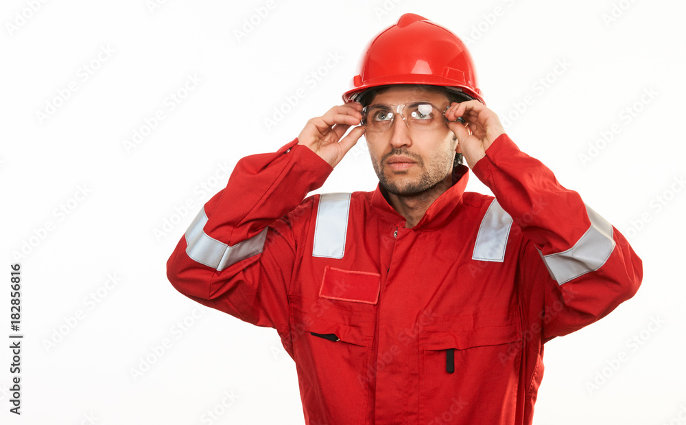 Young construction worker builder in red hard hat Young construction worker builder in red hard hat