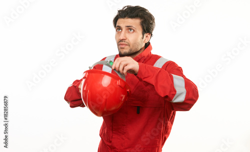 Young engineer worker in a red helmet