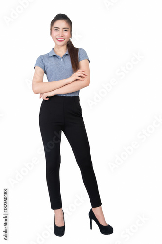 Smiling young woman in gray polo shirt with arms crossed on a white background