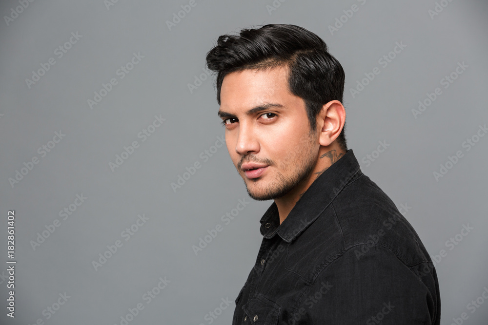 Handsome young serious man standing isolated Handsome young serious man standing isolated