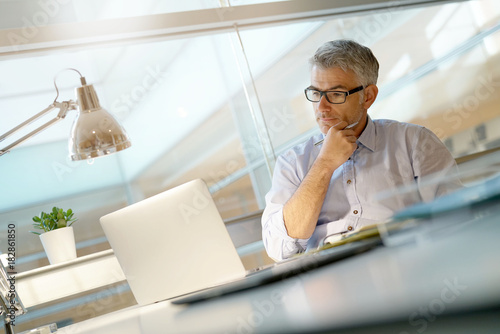 Businessman working in office with laptop computer