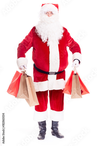 Portrait of Santa Claus posing with bunch of shopping bags on white background