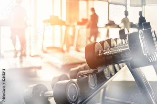 Lifestyle with photo of rows of dumbbells in the gym with hign contrast and monochrome color tone