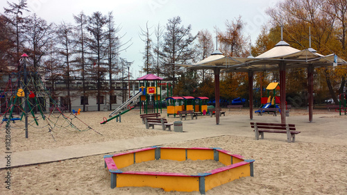 Colorful children's playground on the beach, no people.